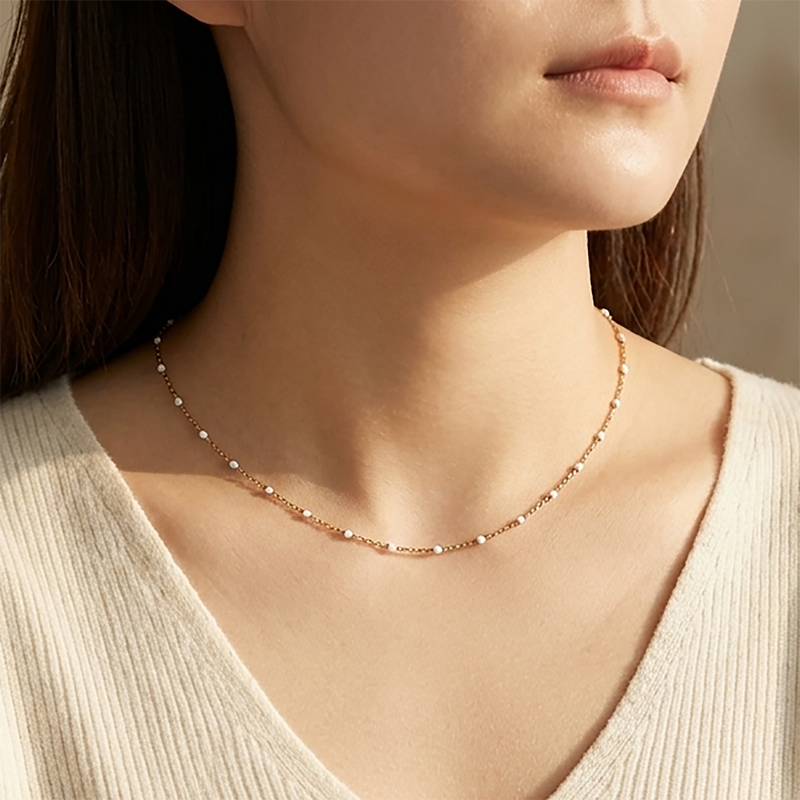 Alba white enamel station necklace worn on model