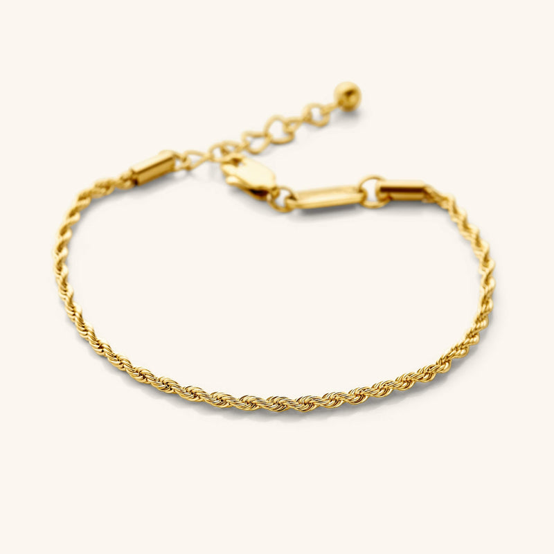 Flat lay of the 18k gold plated Aurelia Rope Bracelet that features a woven chain pattern.