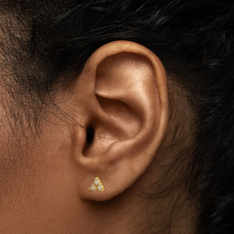 Ayla opal trio stud shown in a healed lobe piercing