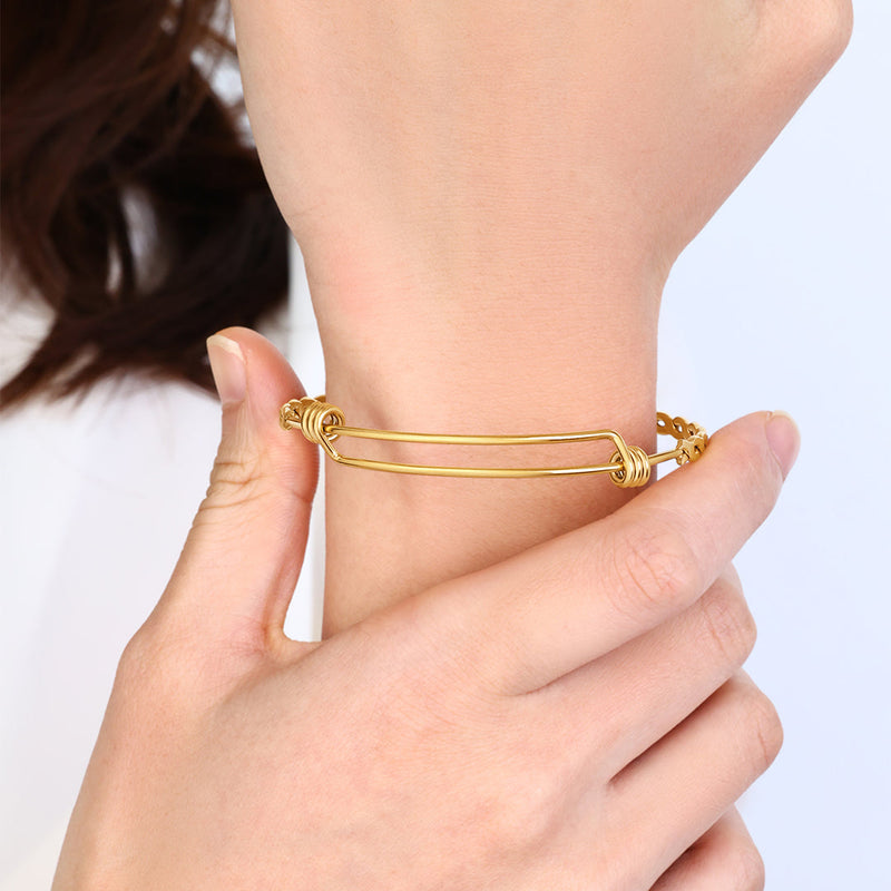 Brielle gold braided bangle adjusted on a wrist