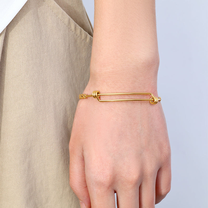 Brielle gold braided bangle worn on a wrist