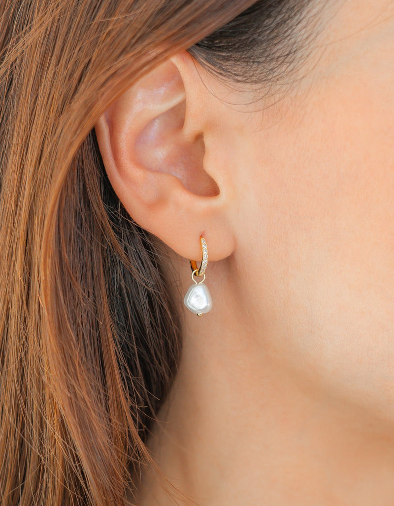 Eira gold freshwater pearl pavé huggie worn in an ear