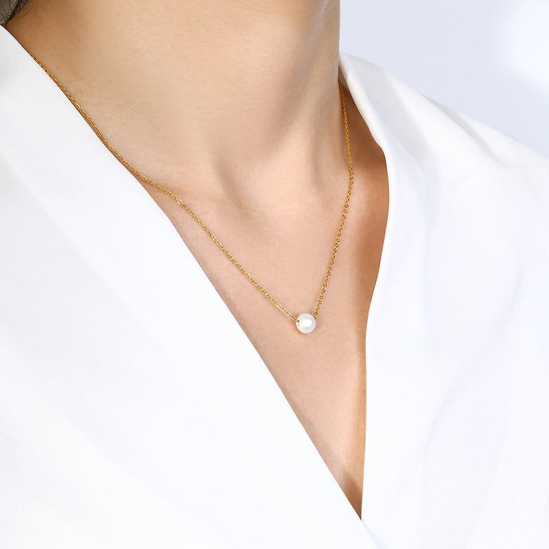 Isla gold-tone pearl necklace worn on model