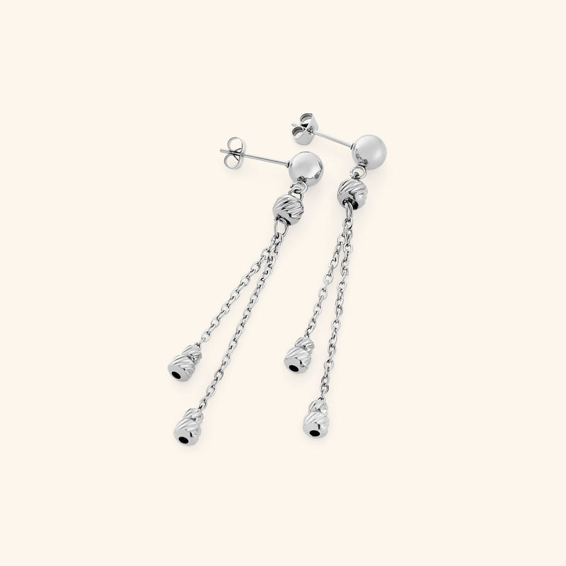 Pair of silver Noor Chain Drop Earrings featuring a polished stud with two slim chains, each ending in ribbed silver bead charms.