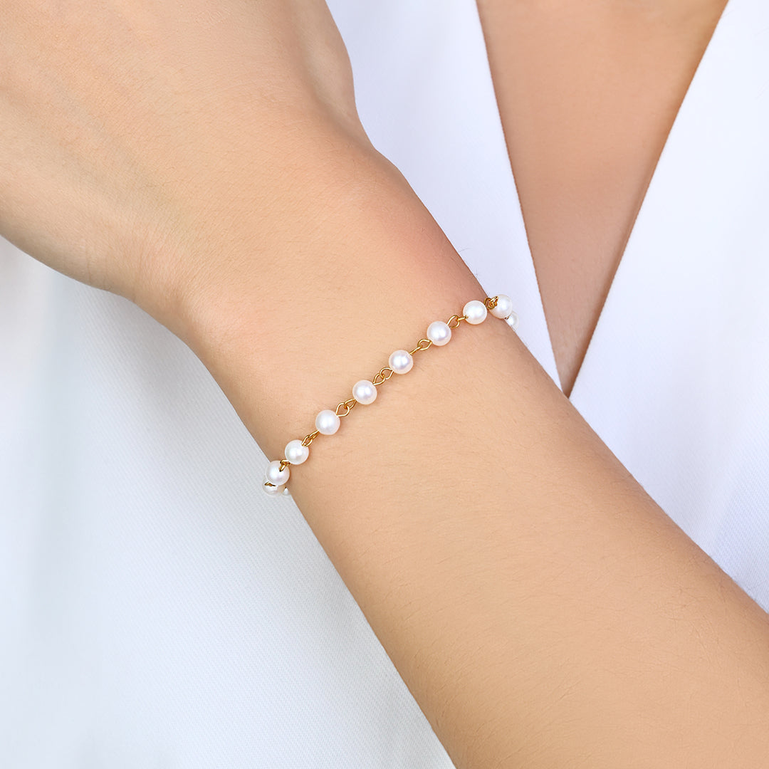 Selene pearl station bracelet worn against soft white