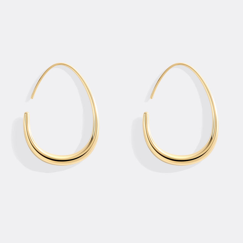 Solis gold fluid hoop earrings angled view