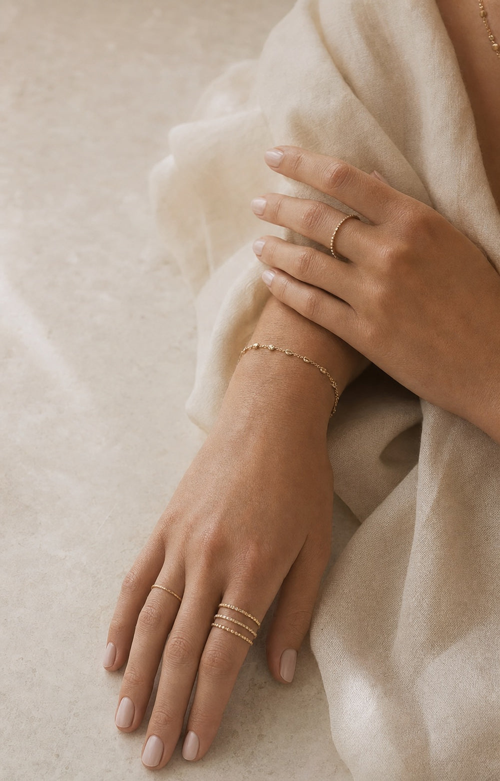 Hands styled with fine rings and a bracelet